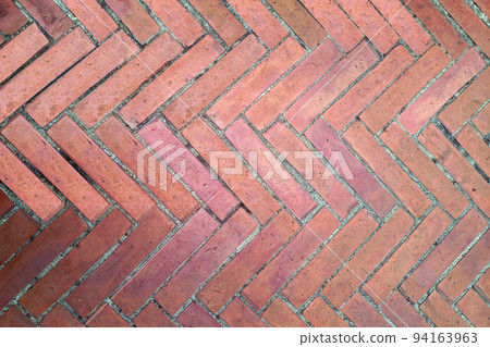 Vintage red brick floor in herringbone or zigzag pattern Vintage red brick floor in herringbone or zigzag pattern 94163963