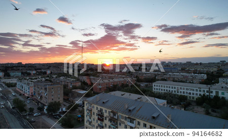 Orange sunset over small town. Top view from drone 94164682
