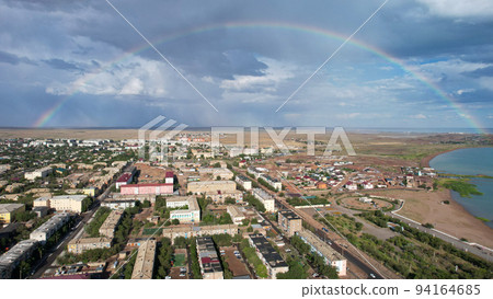 Bright rainbow and rain over the city of Balkhash Bright rainbow and rain over the city of Balkhash 94164685