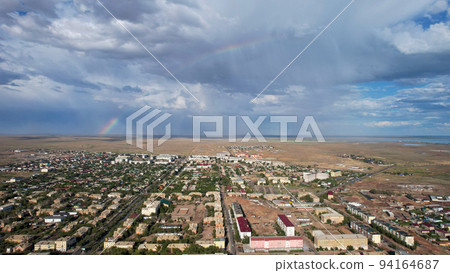 Bright rainbow and rain over the city of Balkhash Bright rainbow and rain over the city of Balkhash 94164687