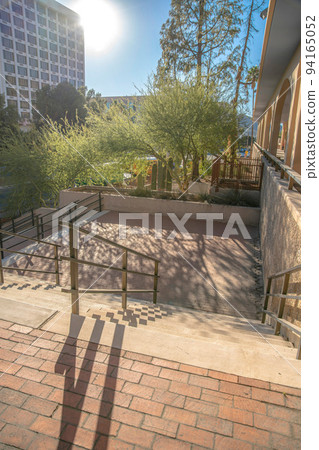 Staircase with bricks and floor mounted handrails at downtown Tucson, Arizona 94165052
