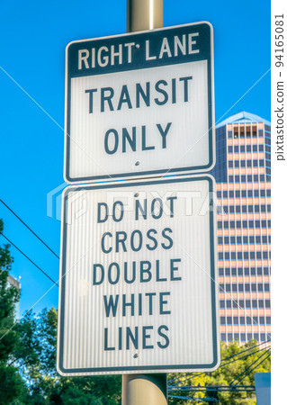 Right lane transit only and do not cross double white lines road signs in downtown Tucson, Arizona 94165081