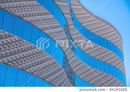 Curved modern building with bricks and reflective glass walls at downtown Tucson, Arizona 94165088