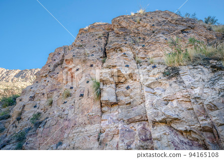 Rocky mountain cliff with rock climbing anchor bolts at Sabino Canyon State Park- Tucson, AZ 94165108