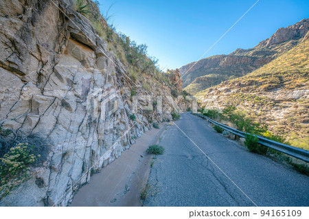 Sabino Canyon State Park, Tucson, Arizona- Road with metal barrier beside the rocky mountain 94165109