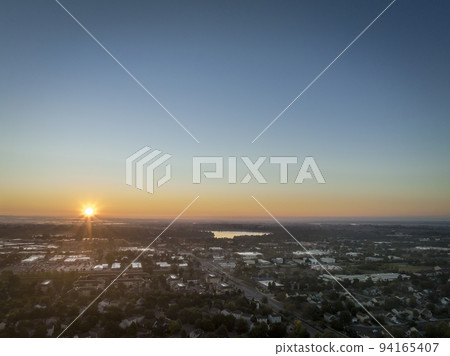 summer sunrise over plains and Fort Collins in Colorado summer sunrise over plains and Fort Collins in Colorado 94165407