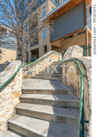 San Antonio, Texas- Concrete staircase with stone walls and handrails at the front of a building San Antonio, Texas- Concrete staircase with stone walls and handrails at the front of a building 94165641