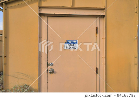 Tucson, Arizona- Notice Door Blocked signage on a cream colored door Tucson, Arizona- Notice Door Blocked signage on a cream colored door 94165782
