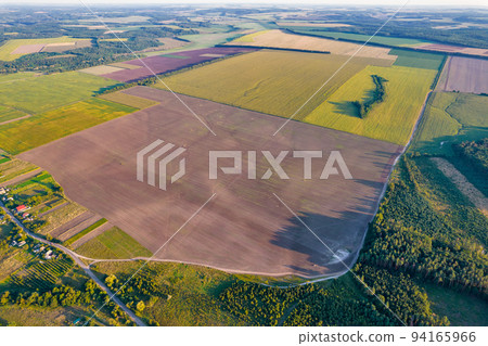 Drone view over summer agricultural fields landscape, Ukraine. Drone view over summer agricultural fields landscape, Ukraine. 94165966