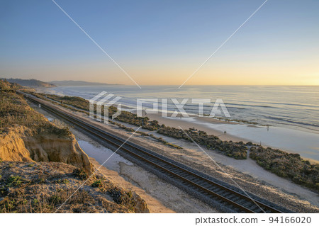 Sunset view of peaceful beach and sea in scenic Del Mar Southern California. 94166020