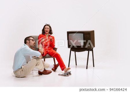 Portrait of cute, loving couple. Man painting woman's nails. Cheerful family evening. 94166424