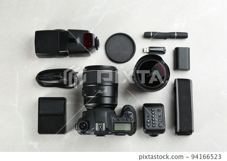 Flat lay composition with equipment for professional photographer on grey marble table 94166523