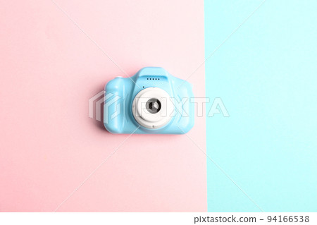 Light blue toy camera on color background, top view. Future photographer Light blue toy camera on color background, top view. Future photographer 94166538