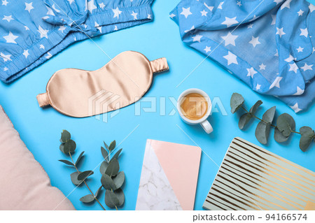 Flat lay composition with sleeping mask on light blue background. Bedtime accessories Flat lay composition with sleeping mask on light blue background. Bedtime accessories 94166574