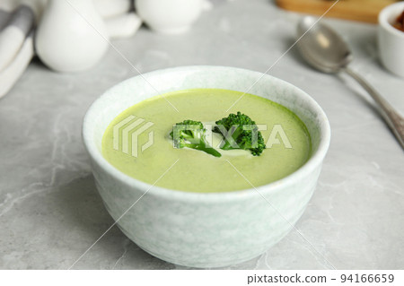 Delicious broccoli cream soup served on grey marble table Delicious broccoli cream soup served on grey marble table 94166659