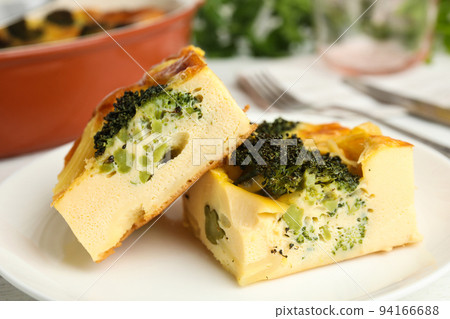 Tasty broccoli casserole on white plate, closeup Tasty broccoli casserole on white plate, closeup 94166688