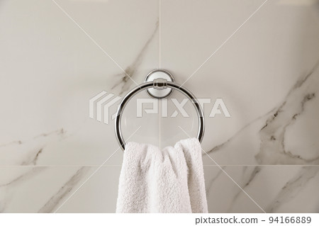 Holder with clean towel on light wall 94166889