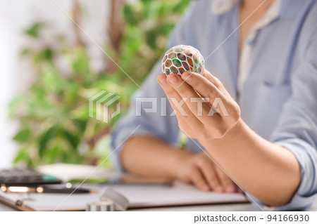 Woman with colorful slime in office, closeup. Antistress toy Woman with colorful slime in office, closeup. Antistress toy 94166930