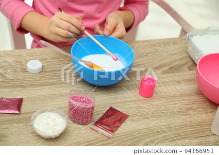 Little girl making homemade slime toy at table, closeup Little girl making homemade slime toy at table, closeup 94166951