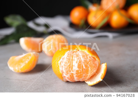 Fresh ripe tangerine on light grey table Fresh ripe tangerine on light grey table 94167028