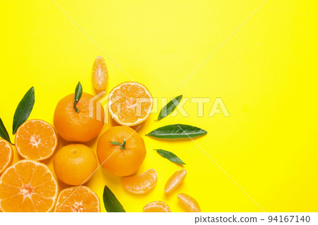 Flat lay composition with fresh ripe tangerines and leaves on yellow background, space for text Flat lay composition with fresh ripe tangerines and leaves on yellow background, space for text 94167140