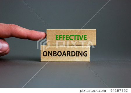 Effective onboarding symbol. Wooden blocks with words Effective onboarding on beautiful grey background. Businessman hand. Business, HR and effective onboarding concept. Copy space. 94167562