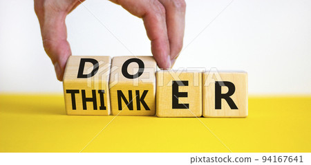 Doer or thinker symbol. Concept words Doer or thinker on wooden cubes. Businessman hand. Beautiful yellow table white background. Business and doer or thinker concept. Copy space. 94167641