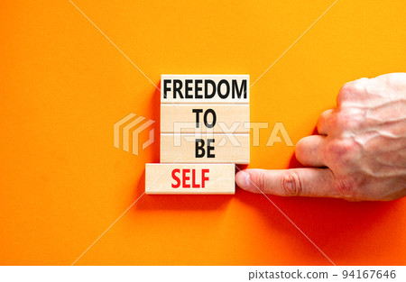 Freedom to be self symbol. Concept words Freedom to be self on wooden blocks on a beautiful orange table orange background. Businessman hand. Business, psychological freedom to be self concept. Freedom to be self symbol. Concept words Freedom to be self on wooden blocks on a beautiful orange table orange background. Businessman hand. Business, psychological freedom to be self concept. 94167646