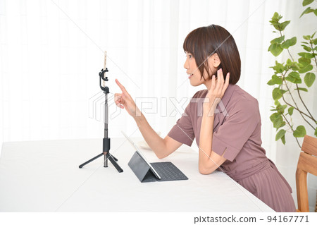 Woman preparing to connect to internet delivery at table 94167771