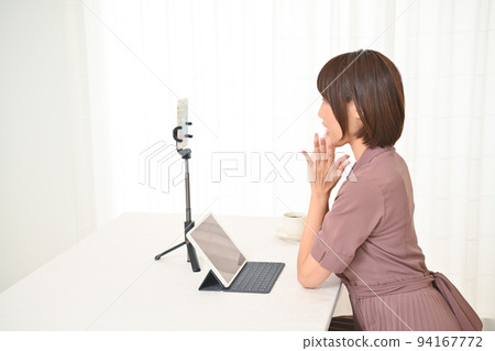 Woman preparing to connect to internet delivery at table 94167772