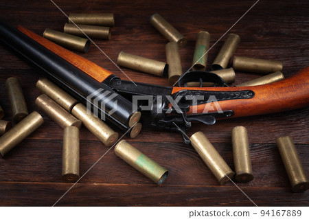 Vintage retro shotgun with brass cartridges 94167889