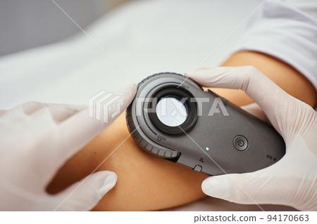 A dermatologist examines the skin. A dermatologist examines the skin. 94170663