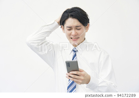 Businessman holding his head with a smartphone on a white background Businessman holding his head with a smartphone on a white background 94172289