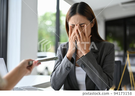 Stressed and depressed Asian female lawyer crying, refusing money or bribe 94173158