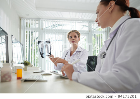Medical researchers analyzing lungs x-rays of patients who recovered from coronavirus Medical researchers analyzing lungs x-rays of patients who recovered from coronavirus 94173201