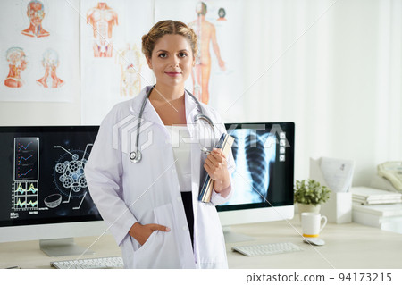 Portrait of young female scientist with tablet computer in hand standing in office of research center 94173215