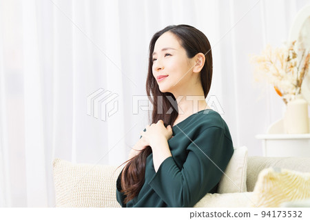 A woman holding her hand on her chest A woman holding her hand on her chest 94173532