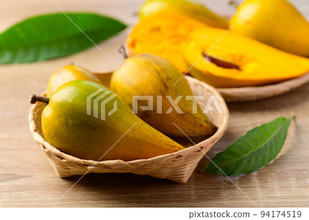 Canistel fruit or Eggfruit in basket on wooden background, Tropical fruit 94174519