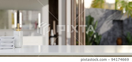 White tabletop with towels, shampoo bottle and copy space over blurred modern bathroom. White tabletop with towels, shampoo bottle and copy space over blurred modern bathroom. 94174669