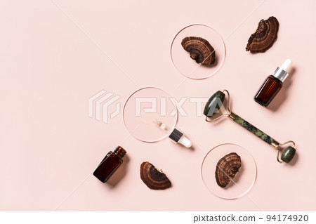 Cosmetic beauty products with mushrooms on pink background. Mushroom skincare concept Cosmetic beauty products with mushrooms on pink background. Mushroom skincare concept 94174920