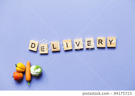 inscription delivery with vegetables and fruits on purple background. delivery service concept inscription delivery with vegetables and fruits on purple background. delivery service concept 94175723