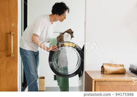 single man doing laundry 94175986