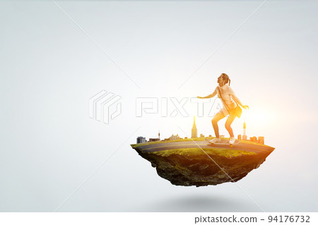 Young woman riding her skateboard Young woman riding her skateboard 94176732