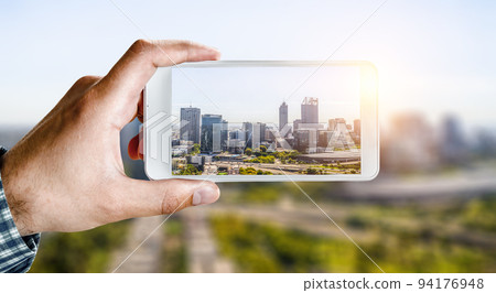 Hand holding smartphone mobile . Mixed media Hand holding smartphone mobile . Mixed media 94176948