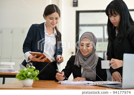 A group of diverse businesspeople working together in the office. Collaboration concept A group of diverse businesspeople working together in the office. Collaboration concept 94177974