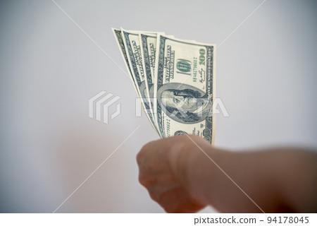 Hand holding loan money dollar bank note give financial payment. Man hands showing spread 100 dollar exchange cash payout. Saving Businessman counting money banknote  bribe corruption concept. 94178045