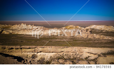 Panorama view to Aral sea from the rim of Plateau Ustyurt at sunset , Karakalpakstan, Uzbekistan Panorama view to Aral sea from the rim of Plateau Ustyurt at sunset , Karakalpakstan, Uzbekistan 94178593