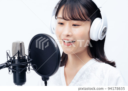 Young woman singing with white headphones Young woman singing with white headphones 94178635