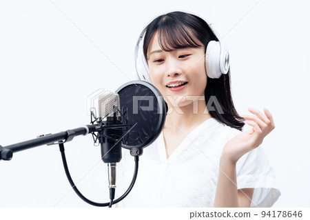 Young woman singing with white headphones 94178646