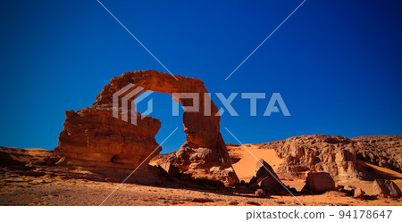 Arch Rock formation aka Arch of Africa or Arch of Algeria with moon at Tamezguida in Tassili nAjjer national park in Algeria 94178647